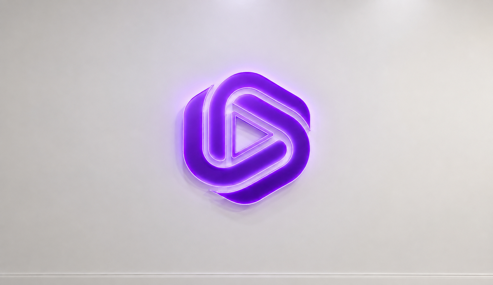 Purple Evolvant logo mounted on a light wall